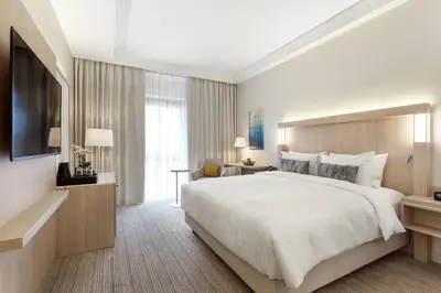 a hotel room with a large bed and a television at Courtyard by Marriott Vilnius City Center in Vilnius