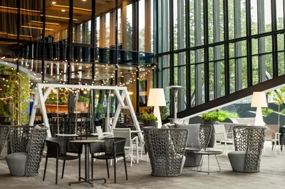 a restaurant with chairs and tables in a building at Courtyard by Marriott Vilnius City Center in Vilnius