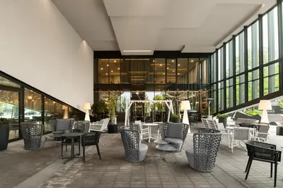 a restaurant with chairs and tables in a building at Courtyard by Marriott Vilnius City Center in Vilnius
