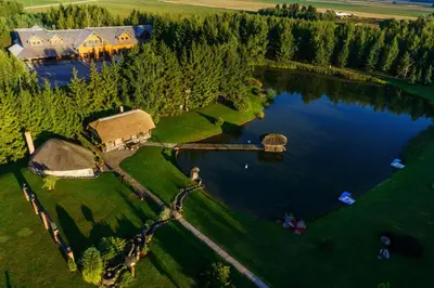 an aerial view of a house on a lake at Sodeliškių dvaro sodyba in Sodeliškiai