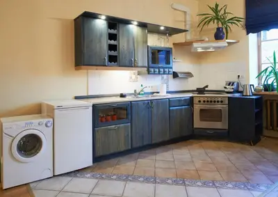 a kitchen with a washing machine and a washer at Regina House- sv. Mikalojaus 13 in Vilnius
