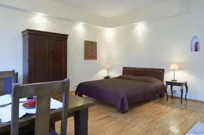 a bedroom with a bed and a cabinet and a table at Regina House- sv. Mikalojaus 13 in Vilnius