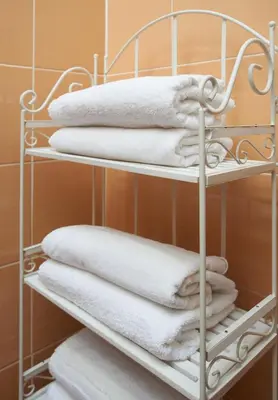 a bunch of towels on a towel rack in a bathroom at Regina House- sv. Mikalojaus 13 in Vilnius