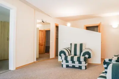 a living room with two chairs and a mirror at Visagino parkas in Visaginas