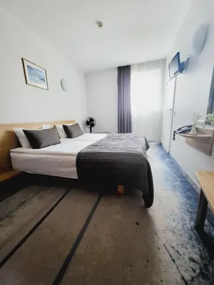 a bedroom with a large bed in front of a window at Green Vilnius Hotel in Vilnius