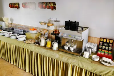 a table with a coffee maker on top of it at Green Vilnius Hotel in Vilnius