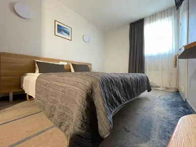 a hotel room with a bed and a window at Green Vilnius Hotel in Vilnius