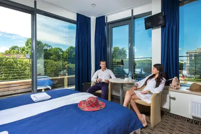 a man and a woman sitting in a hotel room at Kaunas City in Kaunas