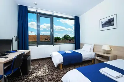a hotel room with two beds and a window at Kaunas City in Kaunas
