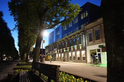 a blue building on a city street with a bench at Kaunas City in Kaunas
