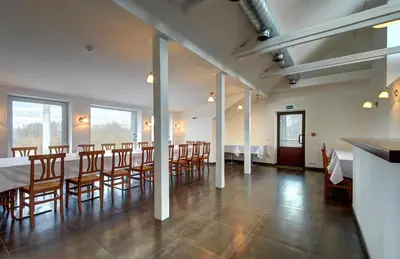 a large dining room with a long table and chairs at Aerohotel in Vilnius