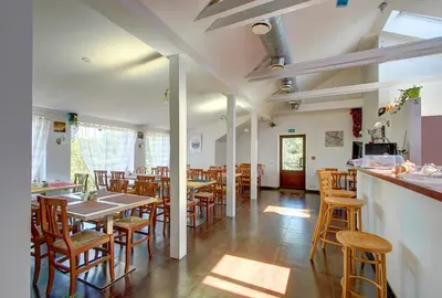 a restaurant with tables and chairs and a bar at Aerohotel in Vilnius