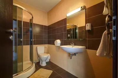 a bathroom with a sink and a toilet and a mirror at Aerohotel in Vilnius