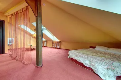 a bedroom with a bed in a attic at Aerohotel in Vilnius