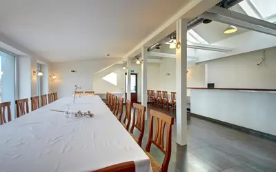 a large room with a long table and chairs at Aerohotel in Vilnius