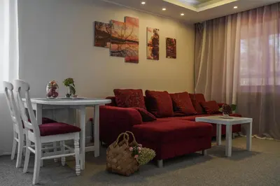 a living room with a couch and a table at Apartamentai Birštono centre su židiniu in Birštonas