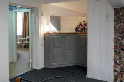 a kitchen with gray cabinets and a counter top at Apartamentai Birštono centre su židiniu in Birštonas