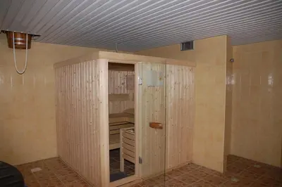 a room with a closet with wooden walls and a ceiling at Hotel-Restaurant Smilga in Kėdainiai