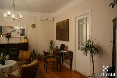 a living room with a table and a desk at Senamiesčio APARTAMENTAI in Panevėžys