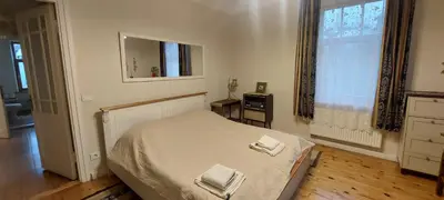 a bedroom with a bed with two towels on it at Senamiesčio APARTAMENTAI in Panevėžys