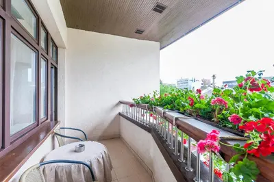 a balcony with flowers and a table and chairs at House Marija in Vilnius