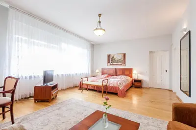 a bedroom with a bed and a tv in a room at House Marija in Vilnius