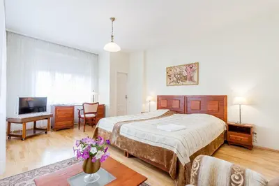 a bedroom with a bed and a desk and a tv at House Marija in Vilnius