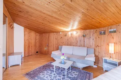a living room with a couch and a wooden ceiling at House Marija in Vilnius