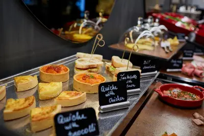 a display case with a bunch of sandwiches and bread at Hotel Pacai, Vilnius, a Member of Design Hotels in Vilnius