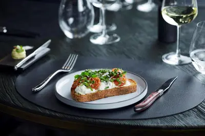 a plate of food on a table with a piece of bread at Hotel Pacai, Vilnius, a Member of Design Hotels in Vilnius
