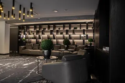 a living room with a couch and a table at Hotel Pacai, Vilnius, a Member of Design Hotels in Vilnius