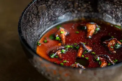 a pot of soup with meat and vegetables in it at Hotel Pacai, Vilnius, a Member of Design Hotels in Vilnius