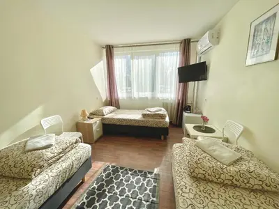 a living room with two beds and a tv at Savan House 