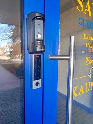 a pay phone on the side of a blue door at Savan House 
