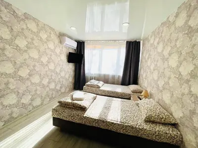 a bedroom with two beds and a window at Savan House 