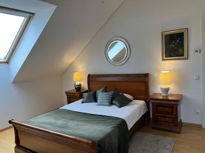 a bedroom with a bed and a mirror in a attic at Villa Sofia Boutique Trakai in Trakai