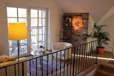 a living room with a table and a window at Villa Sofia Boutique Trakai in Trakai