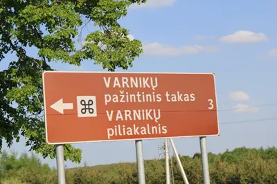 a brown street sign on the side of a road at Villa Sofia Boutique Trakai in Trakai