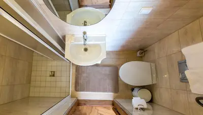 a bathroom with a sink and a mirror at Apartamentai Laima in Druskininkai