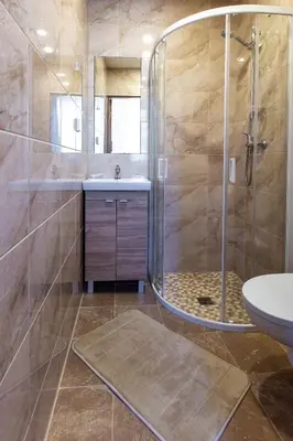 a bathroom with a shower and a sink at Apartamentai Laima in Druskininkai