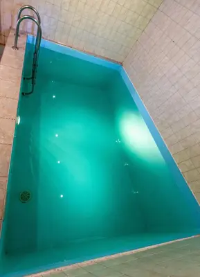 a bath tub with a turquoise at Apartamentai Laima in Druskininkai