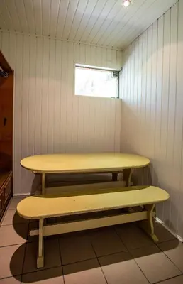 two benches in a small room with a window at Apartamentai Laima in Druskininkai