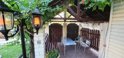 a patio with a table and chairs and a fence at ApartHotel SAVAS 2 Apartments in Kaunas and parking in Kaunas