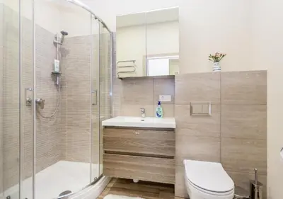 a bathroom with a shower and a toilet and a sink at Apartamentai 