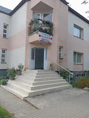 a building with a sign that reads welcome to a hotel at Aleks in Zarasai