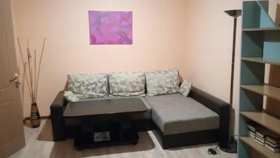 a living room with a couch and a painting on the wall at Aleks in Zarasai