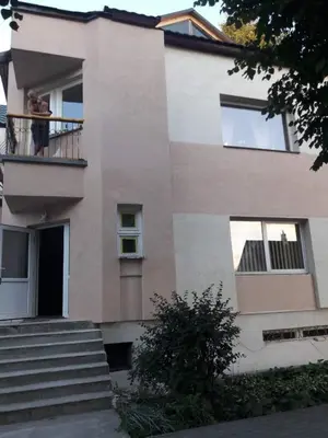 a man standing on a balcony of a house at Aleks in Zarasai