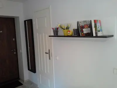 a room with a white door with a shelf on the wall at Lima Studio in Druskininkai