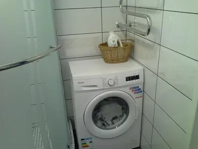 a washing machine with a basket on top of it at Lima Studio in Druskininkai