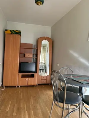 a dining room with a table and a entertainment center at Tilto 6 in Vilnius